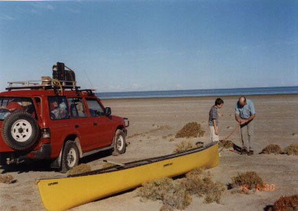 unloading canoe outback south australia lake eyre in flood